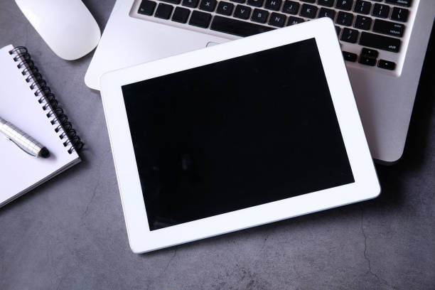istock Top view of digital tablet, laptop and notepad on table 1225821976