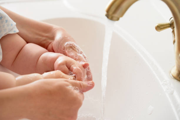 istock Mother and child wash their hands 1225822181
