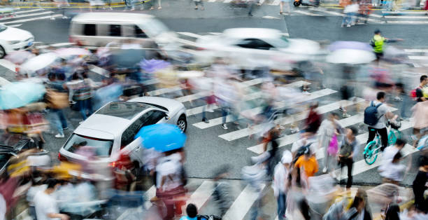 istock Motion blurred people and cars on the sidewalk 1225822391