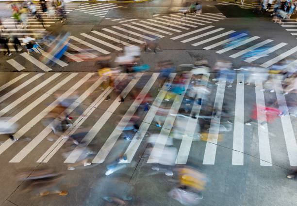 istock Motion blurred crowd of people walking on crosswalk 1225822657