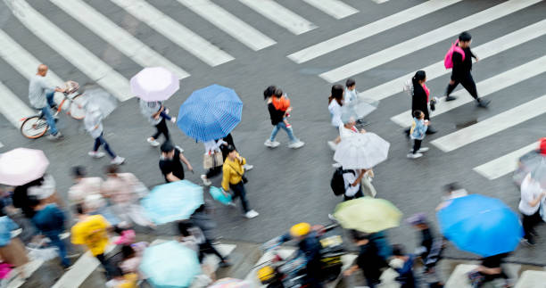 istock Motion blurred crowd of people walking on crosswalk 1225822659