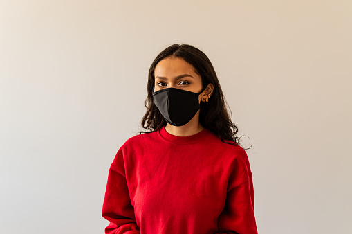 a young woman of red shirt and black mask