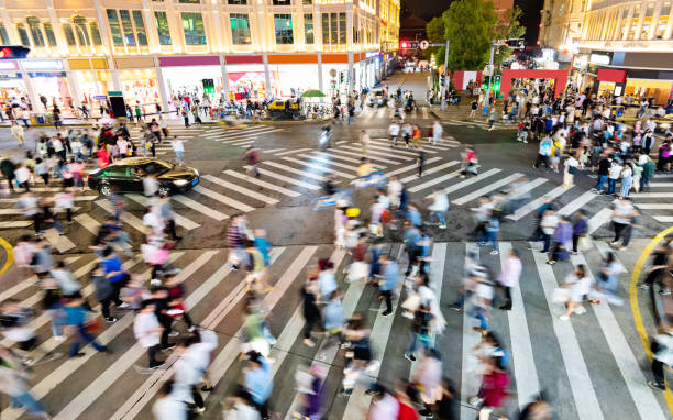 istock Motion blurred crowd of people walking on crosswalk 1225823304