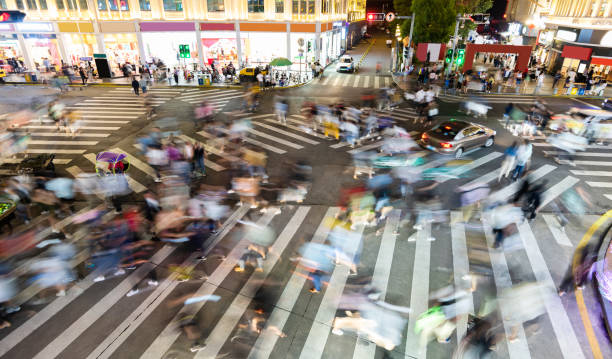 istock Motion blurred crowd of people walking on crosswalk 1225823453