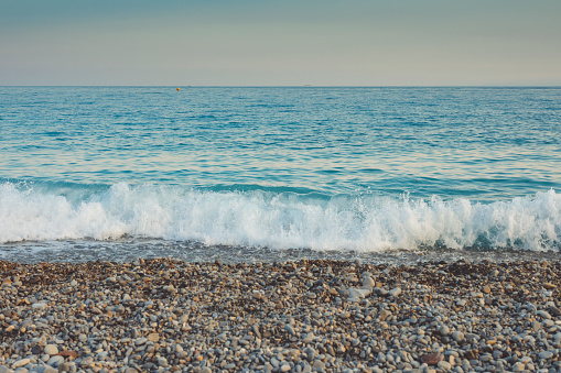 The Mediterranean sea and pebbles stones on a beach in Nice, France