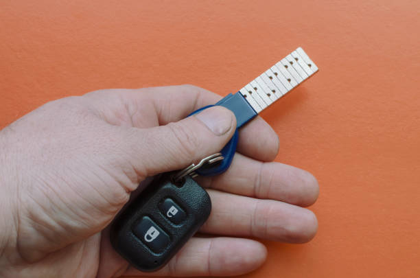 istock A male hand holds the keys to a modern SUV. 1225823767