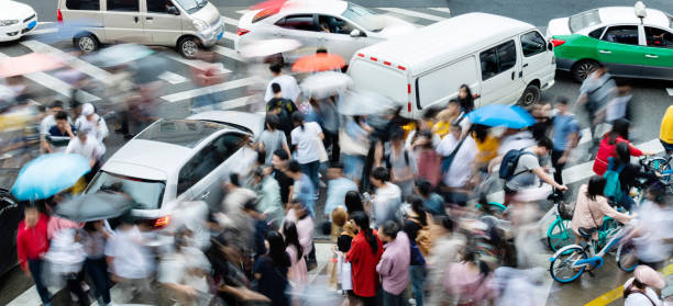 istock Motion blurred people and cars on the sidewalk 1225824723
