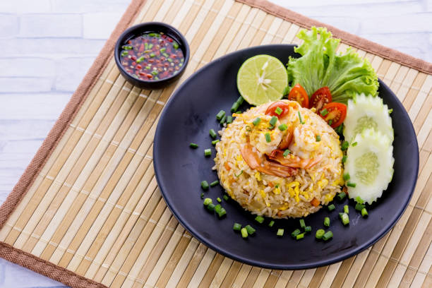 Fried rice with prawn Fried rice with prawn on wooden table fried rice stock pictures, royalty-free photos & images