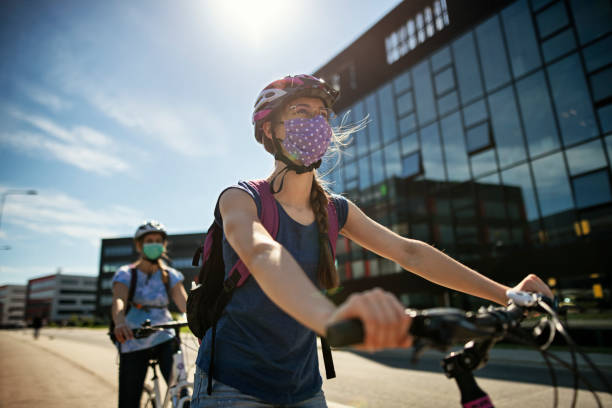 Mother and daughter riding bikes during Covid-19 pandemic Mother and daughter are enjoying a bike trip together in the modern residential area. They are wearing obligatory face masks.
Nikon D850 corona sun photos stock pictures, royalty-free photos & images