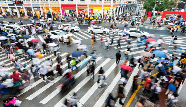 istock Motion blurred people and cars on the sidewalk 1225826414