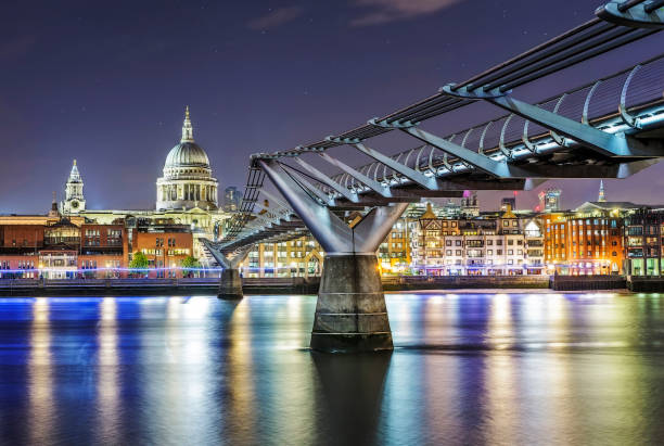 St Paul's cathedral on the thames by Millenium Bridge in the blue hour in London St Paul's cathedral on the thames by Millenium Bridge in the blue hour in London thames river photos stock pictures, royalty-free photos & images