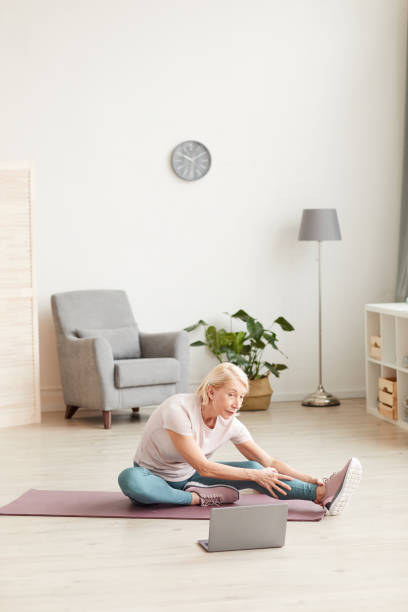 istock Woman stretching at home 1225827985