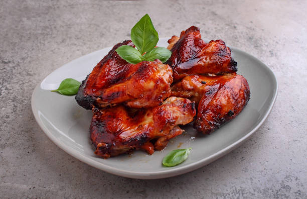 istock Grilled chicken wings in soy sauce decorated with basil in a plate 1225829953