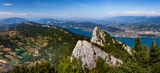 Breathtaking panoramic view of the summit of La Dent Du Chat mountain, famous local landmark. This photo was taken during a sunny summer day from the top of La Dent Du Chat mountain peak in end of Bugey mountains, European Alps in border of Ain and Savoie department, near Aix-les-Bains famous city on the shore of Lake Bourget in Auvergne-Rhone-Alpes region in France, Europe.