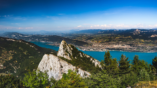 Breathtaking panoramic view of the summit of La Dent Du Chat mountain, famous local landmark. This photo was taken during a sunny summer day from the top of La Dent Du Chat mountain peak in end of Bugey mountains, European Alps in border of Ain and Savoie department, near Aix-les-Bains famous city on the shore of Lake Bourget in Auvergne-Rhone-Alpes region in France, Europe.