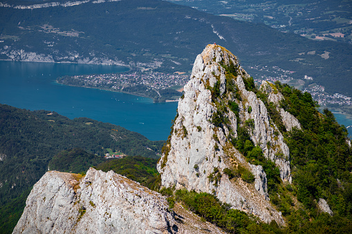 Breathtaking panoramic view of the summit of La Dent Du Chat mountain, famous local landmark. This photo was taken during a sunny summer day from the top of La Dent Du Chat mountain peak in end of Bugey mountains, European Alps in border of Ain and Savoie department, near Aix-les-Bains famous city on the shore of Lake Bourget in Auvergne-Rhone-Alpes region in France, Europe.