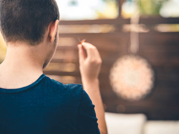 Teenager playing Darts outside