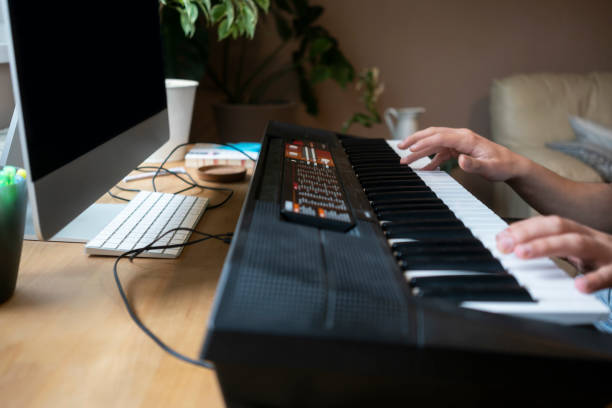 istock Teenage boy playing on electronic keyboard - piano 1225832134