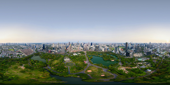 360 panorama by 180 degrees angle seamless panorama of aerial of green trees in Lumpini Park, Sathorn, Bangkok Downtown Skyline. Thailand. Financial district in urban city. Skyscraper buildings.