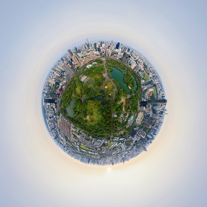 Little planet 360 degree sphere. Panorama of aerial of green trees in Lumpini Park, Sathorn, Bangkok Downtown Skyline. Thailand. Financial district in urban city. Skyscraper buildings at sunset.