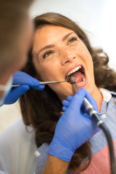 istock Dentist examining teeth of female patient 1225838046