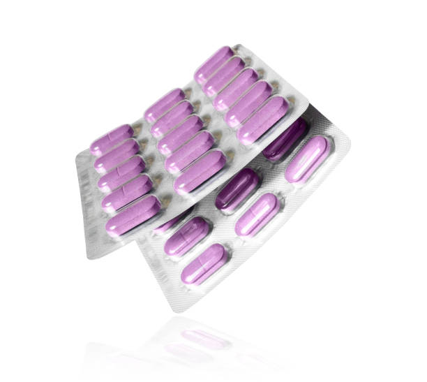 istock Two blister packs with pills close-up on white background 1225840554