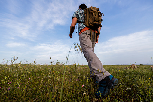 Traveler with a backpack walking in the nature
