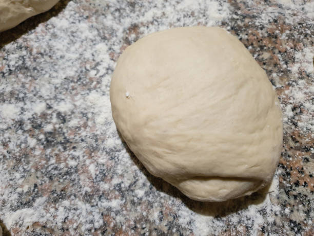 istock homemade dough on dusted flour - top view 1225840794