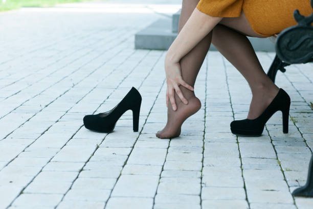 istock woman hand in ache  feet 1225842108