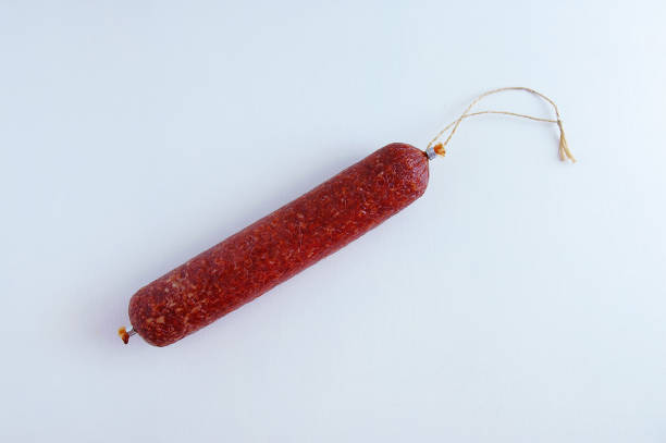 istock Smoked sausage on a white background close-up. View from above 1225842652