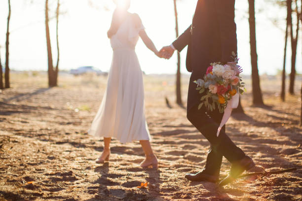 istock Bride and groom holding hands 1225842691
