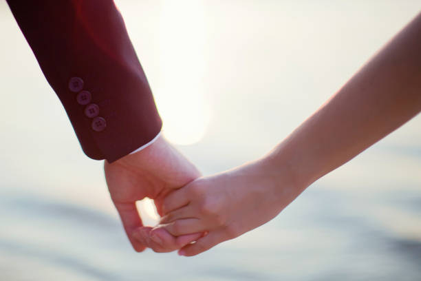 istock Young man and woman holding hands 1225842831