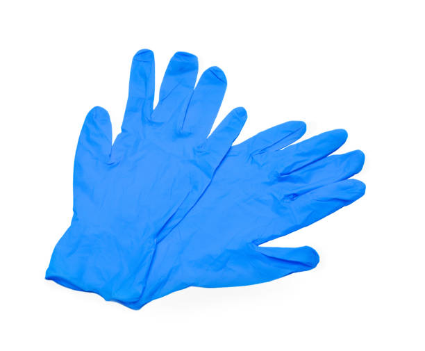 par de guantes médicos azules sobre un fondo azul - surgical glove fotografías e imágenes de stock