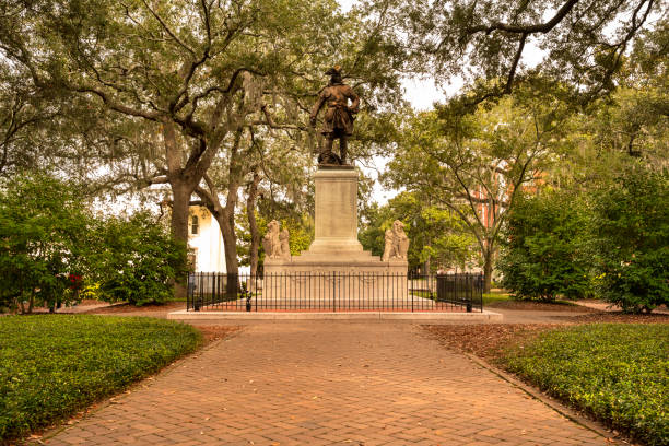 Savannah, USA - November 30, 2019:  People walk along the cobblestone paths of historic Chippewa Square Park in Savannah Georgia USA