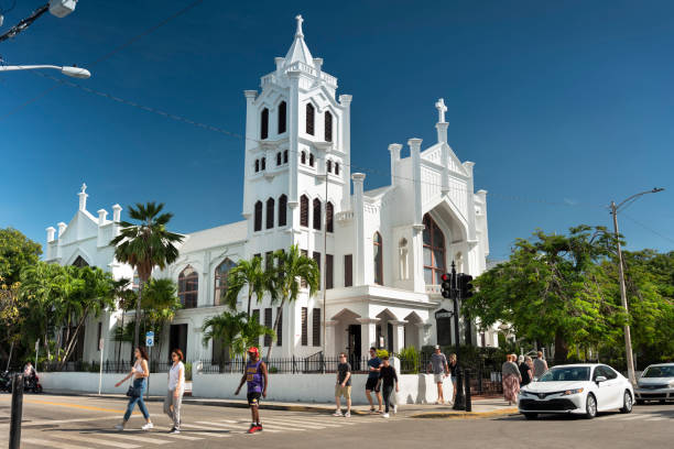 Key West, Florida - December 4, 2019: People walk by St. Paul's Episcopal Church on famous Duval Street in Key West Florida USA.