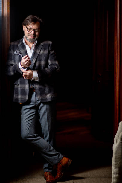 istock Confident restaurant owner standing against wine cabinet 1225846321