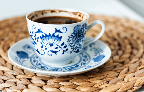 istock Black coffee espresso in a porcelain cup on a wicker stand, cozy home interior decor 1225846647