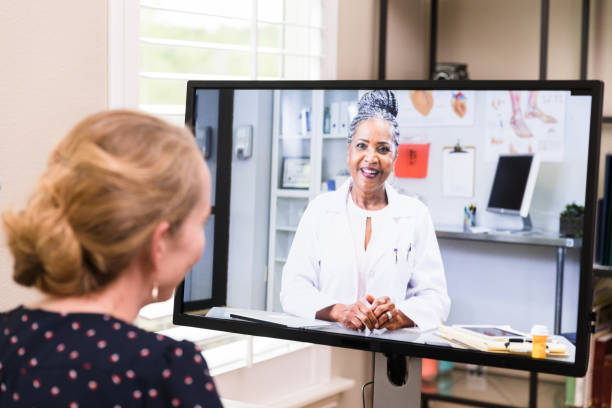 istock Unrecognizable woman video conferences with doctor 1225848823