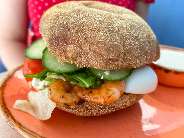 istock Tasty burger with shrimp, egg and fresh cucumber 1225848966