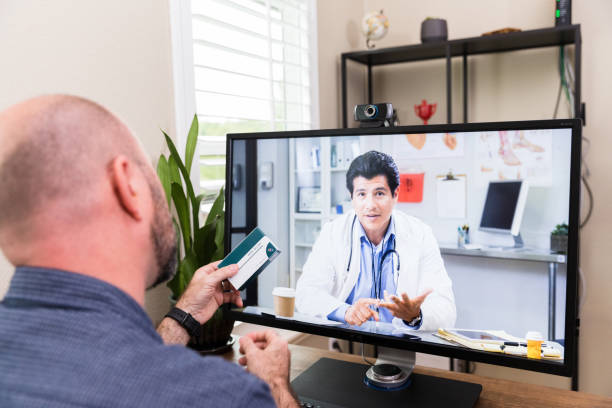 istock Male doctor explains side effects of medication unrecognizable man holds 1225848986