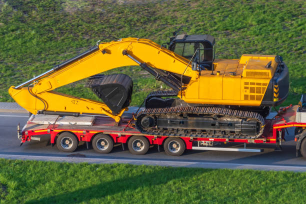 yellow excavator on truck