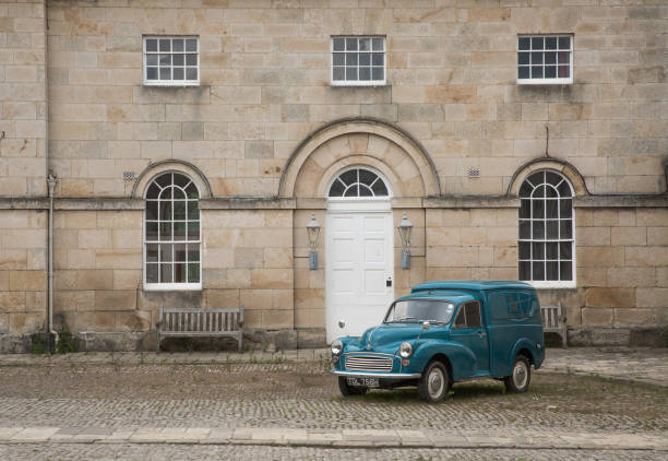 CASTLE HOWARD, YORKSHIRE, UK - MAY 19, 2020.  The entrance and courtyard of Castle Howard near York in North Yorkshire with a vintage Morris Minor panel Van