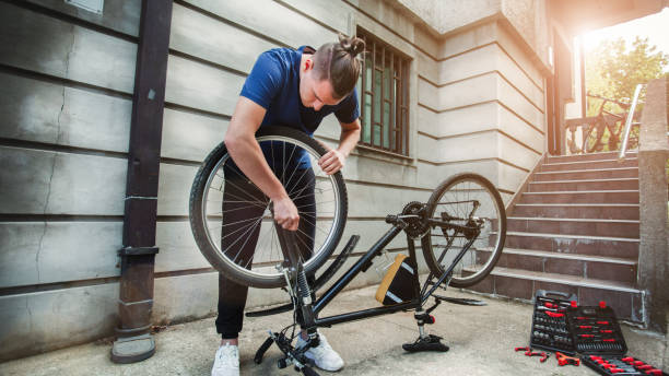 istock Young man repairing bicycle 1225853595