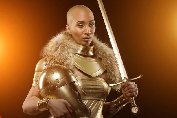 Golden viking inspired warrior female in studio shot Golden viking inspired black warrior female in studio shot warrior person stock pictures, royalty-free photos & images