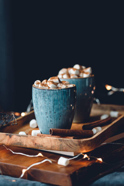istock Hot chocolate with marshmallow and cinnamon in blue ceramic cups on a table. The concept of cosy holidays and New Year. 1225854046