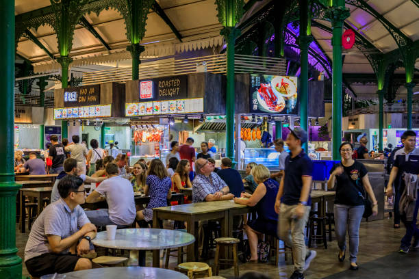 Locals and tourists, customers eating at the street hawker center in Lau Pa Sat Telok Ayer Market, Singapore Singapore - September 07, 2019:  Locals and tourists, customers walking through and eating at the street hawker center in Lau Pa Sat Telok Ayer Market market vendor stock pictures, royalty-free photos & images