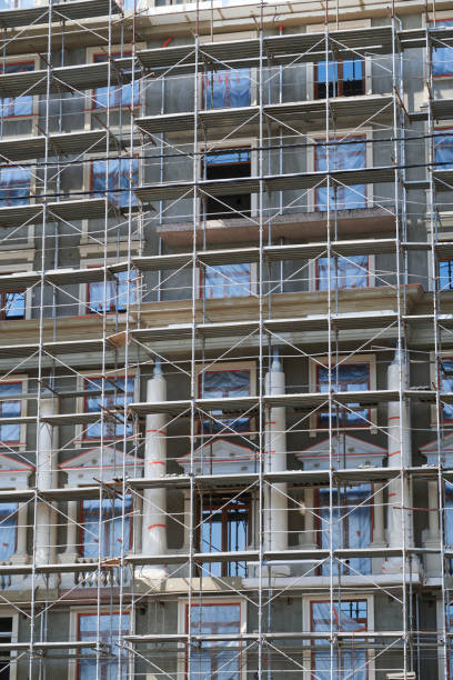 istock scaffolding at the facade of a building under construction, multi-storey building, without people 1225860277