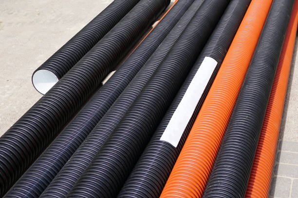 istock new orange and black plastic pipes on construction site 1225861592