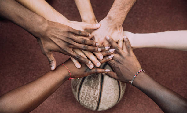 istock Basketball team stacking hands in the court 1225862953