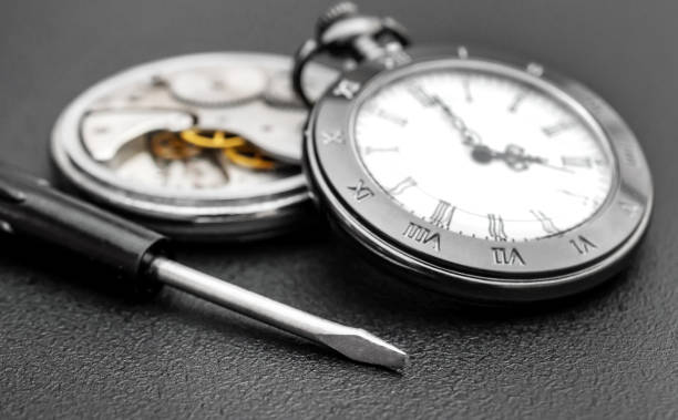 istock Broken pocket watch and new pocket watch with screwdriver on black background. Clockwork. 1225863135